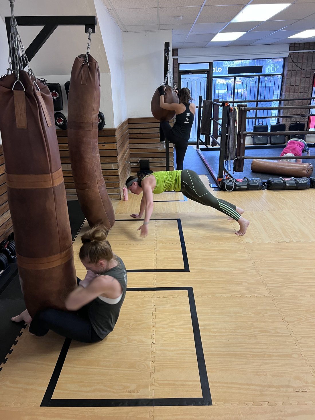 Bootcamp members doing heavy bag and conditioning work