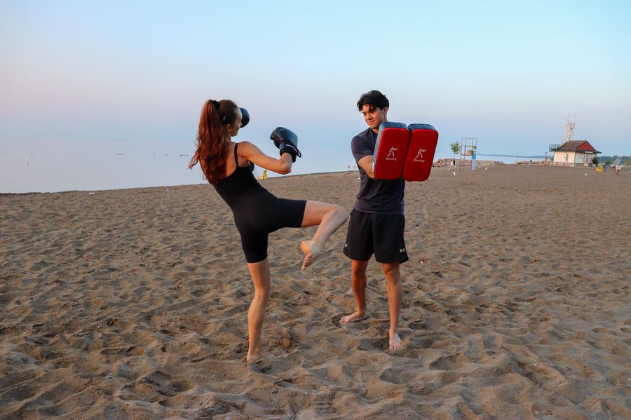 High kick training on the beach at sunrise